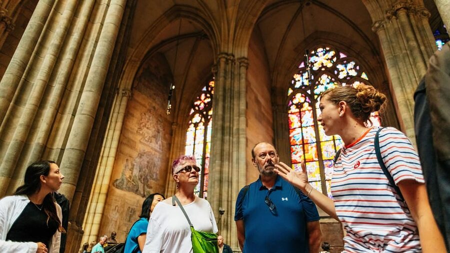 Prague Castle Interiors, Bus Tour and Vltava River Cruise - Entering the castle complex with a guide