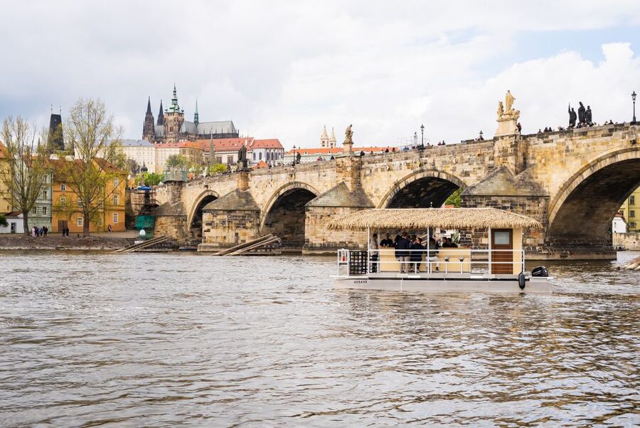Prague: Party Tiki Boat Sightseeing Cruise with Drinks - Finding the unusual boat near the river